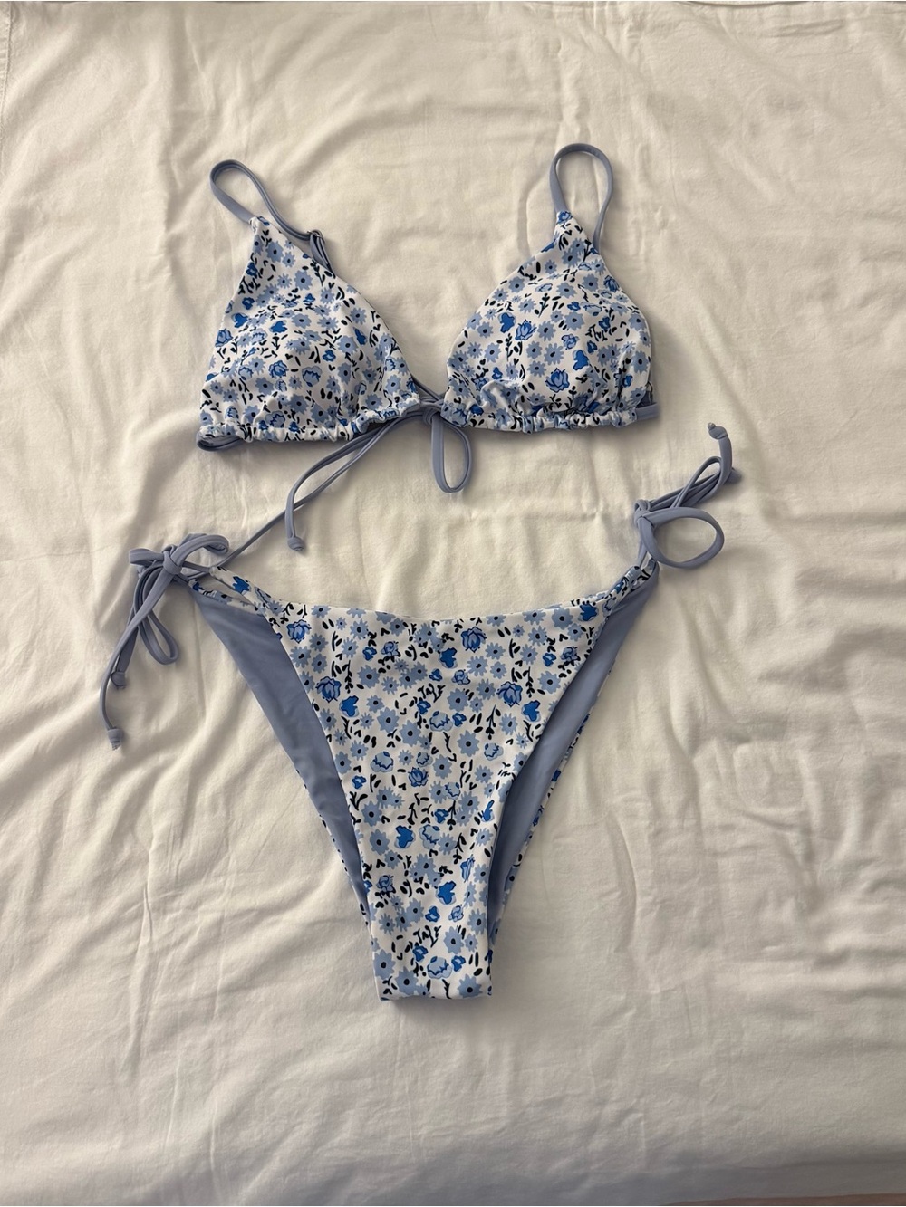 Blue floral bikini set with small blue flowers on white background